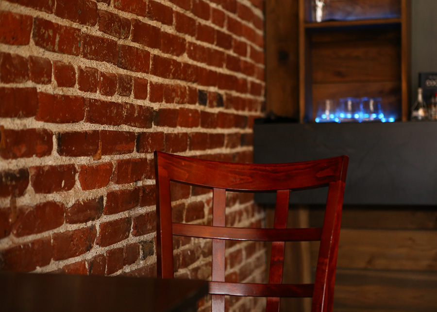 Exposed brick lines the walls of the downstairs bar